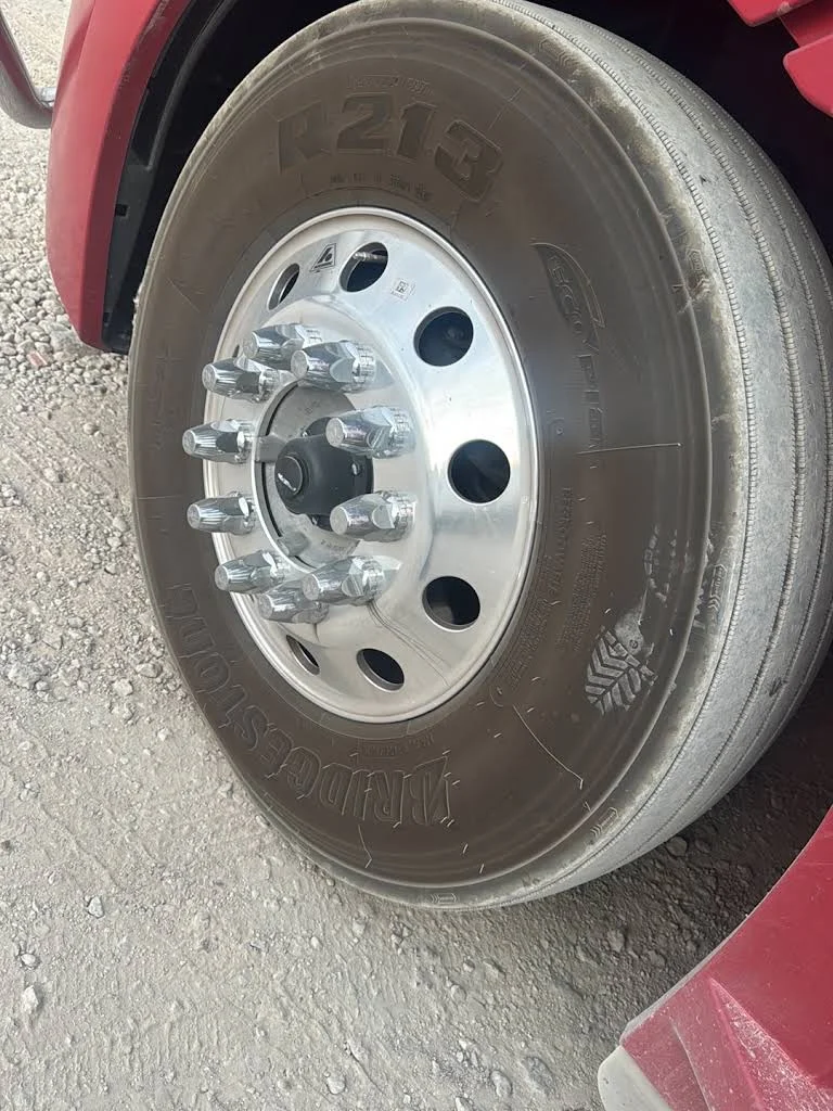 Red semi truck front wheel and tire
