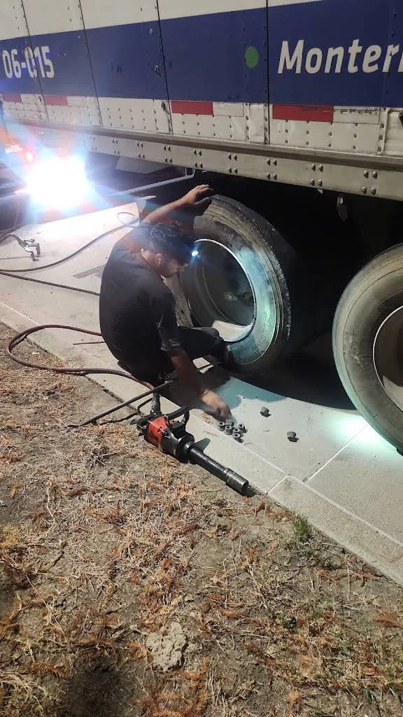 Trailer wheel service illuminated by a work light