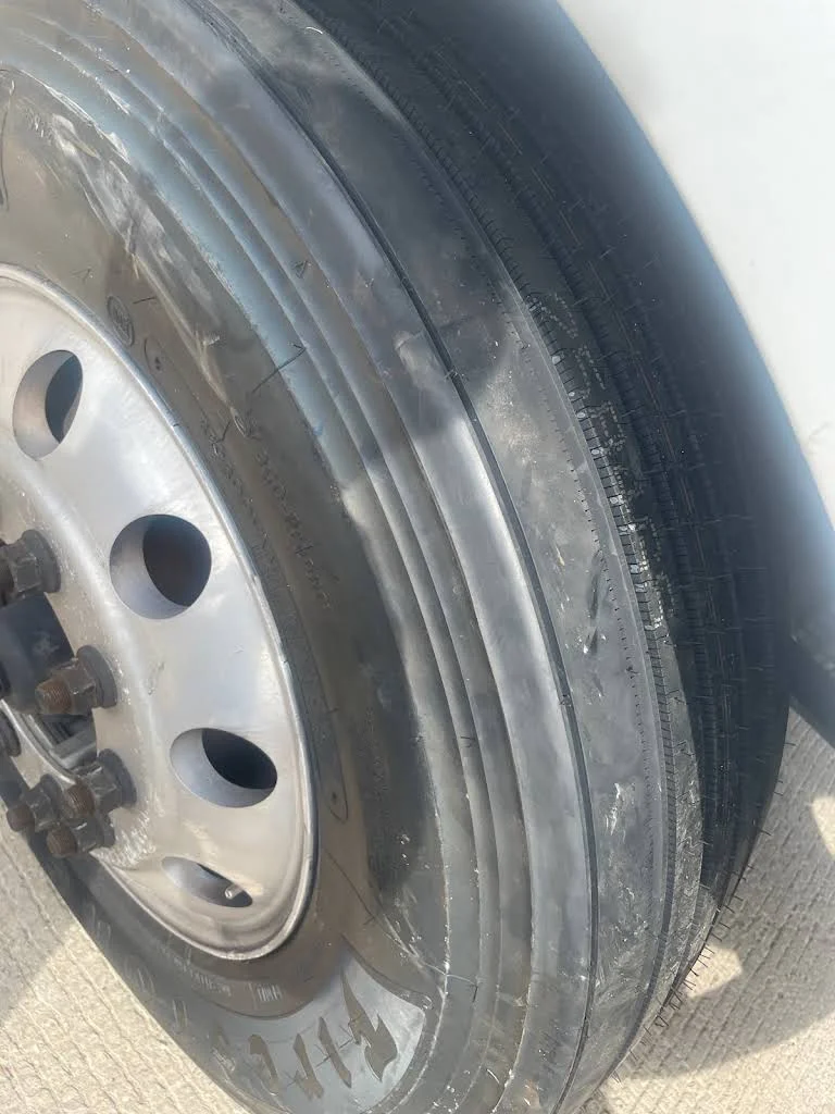 Close view of a semi truck tire and wheel